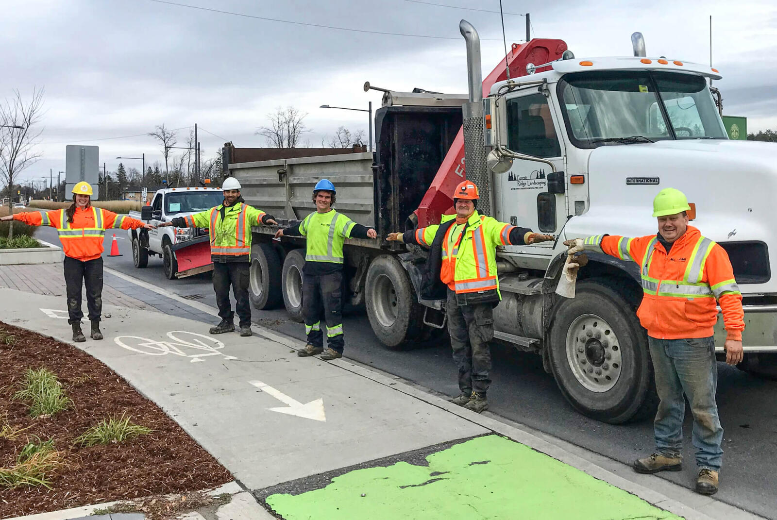 Forest Ridge Landscaping construction teams members, Taylor K., Rick M., Taylor R., Carl S., and Carl J., demonstrate on-the-job physical distancing.