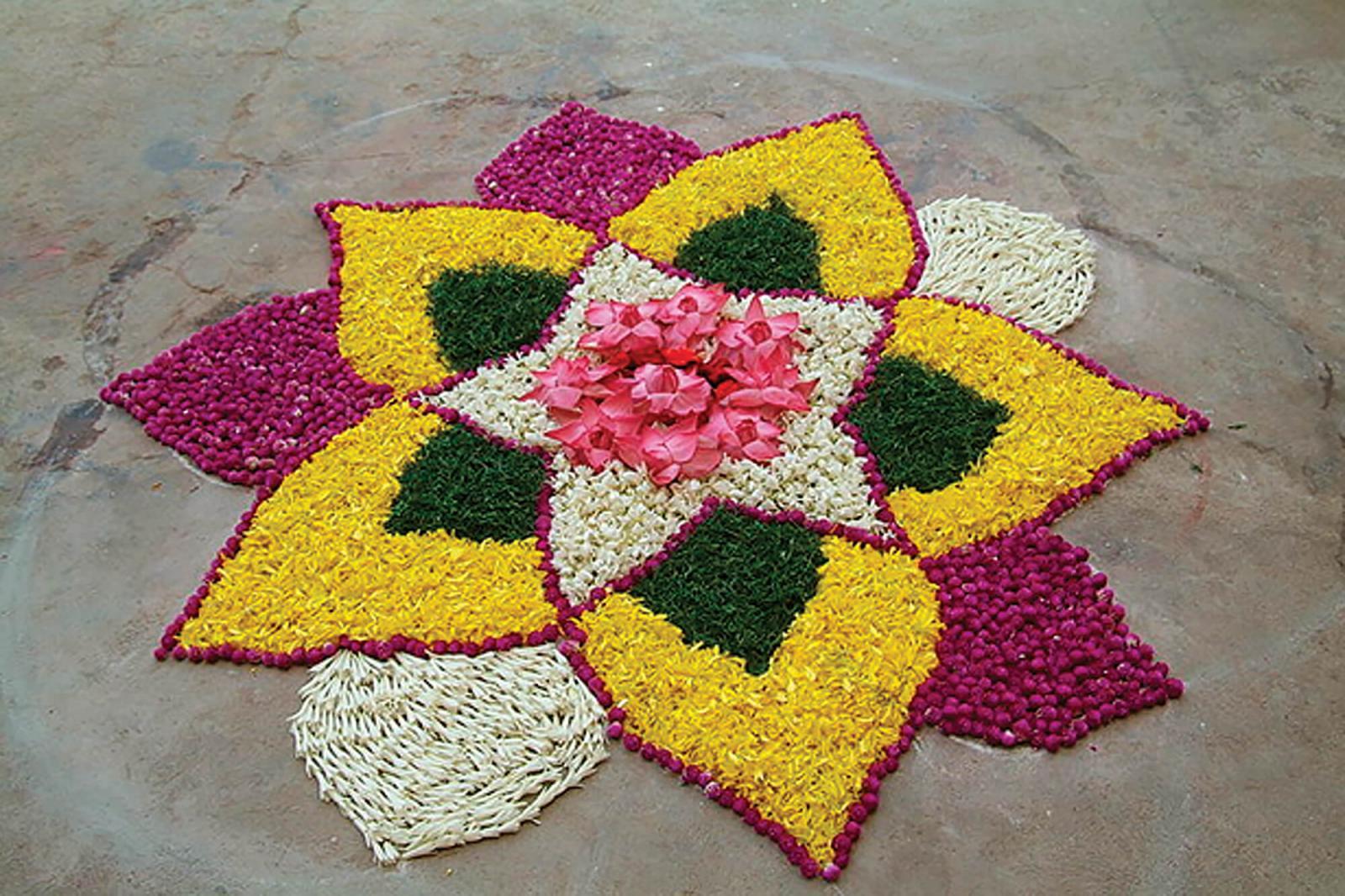 Flower heads and flower petals used to make a rangoli design.