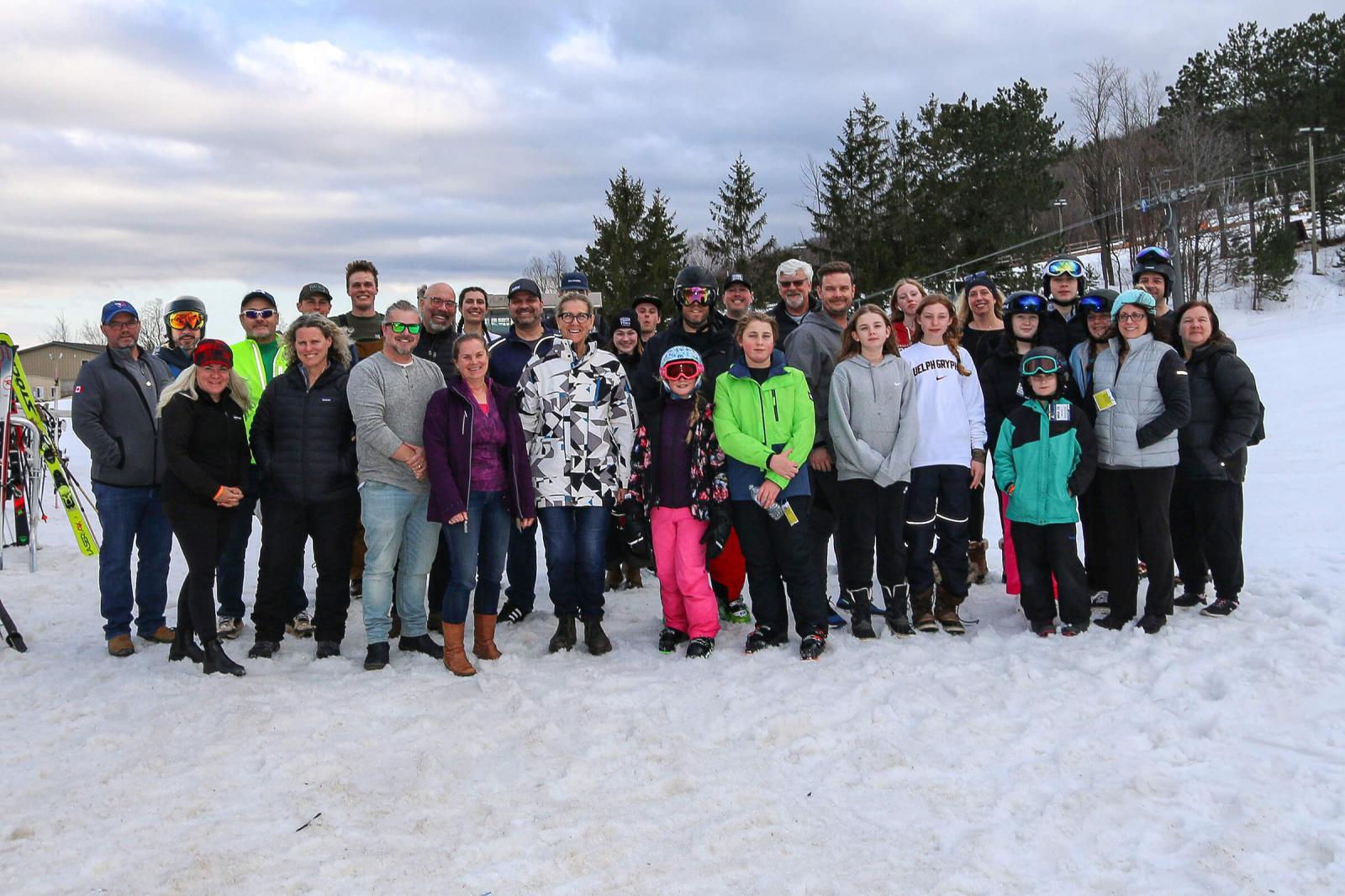 Participants of the 2023 Snow Day gathered for a group photo at the base of the ski hill.